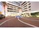 Modern building exterior with brick pavers, fountain, and ample parking at 150 E Robinson St # 3106, Orlando, FL 32801