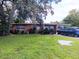 Front view of ranch house with landscaping and driveway at 222 Ronnie Cir, Orlando, FL 32811