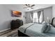Spacious bedroom with large TV, dresser, and window with blinds at 3356 Robert Trent Jones Dr # 101, Orlando, FL 32835