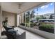 Cozy screened porch with two wicker chairs overlooking the community at 3356 Robert Trent Jones Dr # 101, Orlando, FL 32835