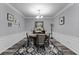 Elegant dining room featuring a round table and four chairs, with stylish rug and decor at 3356 Robert Trent Jones Dr # 101, Orlando, FL 32835
