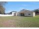 Spacious backyard with a large grassy area and a view of the home's back at 3922 Old Dunn Rd, Apopka, FL 32712