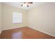 Well-lit bedroom featuring hardwood floors and a large window at 3922 Old Dunn Rd, Apopka, FL 32712