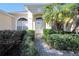 Front entryway with a white door, stone pathway, and neatly trimmed landscaping at 3922 Old Dunn Rd, Apopka, FL 32712