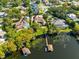 Bird's eye view of lakefront property showcasing home, pool, dock, and neighborhood at 4024 W Danby Ct, Winter Springs, FL 32708
