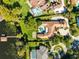 Large estate home on waterfront lot with pool, circular driveway, and boat dock at 4024 W Danby Ct, Winter Springs, FL 32708