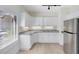 Modern kitchen featuring white cabinets and a curved counter at 4024 W Danby Ct, Winter Springs, FL 32708