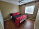 Bright bedroom featuring a red and black comforter and hardwood floors at 5055 Fiorella Ln, Sanford, FL 32771