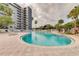 Resort-style pool with surrounding lounge chairs at 6165 Carrier Dr # 2602, Orlando, FL 32819