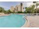 Resort-style pool with plenty of lounge chairs at 6165 Carrier Dr # 2602, Orlando, FL 32819