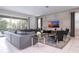 Bright living room featuring a sectional sofa and large TV at 9043 Sunshine Ridge Loop, Kissimmee, FL 34747