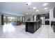 Open kitchen with island, stainless steel appliances, and granite countertops at 9043 Sunshine Ridge Loop, Kissimmee, FL 34747
