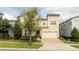 Two-story house with stone accents and a two-car garage at 9043 Sunshine Ridge Loop, Kissimmee, FL 34747