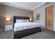 Main bedroom with gray upholstered bed and window at 9043 Sunshine Ridge Loop, Kissimmee, FL 34747