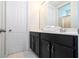 Clean bathroom with dark vanity and shower/tub combo at 9043 Sunshine Ridge Loop, Kissimmee, FL 34747