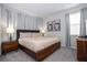 Bedroom with a king bed, mid-century modern nightstands, and gray walls at 9043 Sunshine Ridge Loop, Kissimmee, FL 34747