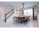 Elegant dining room with large wood table and seating for eight at 9043 Sunshine Ridge Loop, Kissimmee, FL 34747
