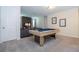 Game room with a pool table and comfortable seating area at 9043 Sunshine Ridge Loop, Kissimmee, FL 34747