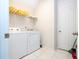 Laundry room with washer, dryer, and shelving at 9043 Sunshine Ridge Loop, Kissimmee, FL 34747