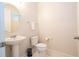 Clean and simple powder room with pedestal sink and toilet at 9043 Sunshine Ridge Loop, Kissimmee, FL 34747