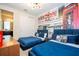 Bedroom with two twin beds, London-themed wall mural, and ensuite bathroom at 9043 Sunshine Ridge Loop, Kissimmee, FL 34747