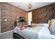 Bedroom with twin beds and a brick feature wall at 9043 Sunshine Ridge Loop, Kissimmee, FL 34747