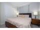 Bedroom with a king bed, mid-century modern nightstands, and gray walls at 9043 Sunshine Ridge Loop, Kissimmee, FL 34747