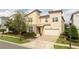 Two-story house with stone accents and a two-car garage at 9043 Sunshine Ridge Loop, Kissimmee, FL 34747