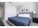 Main bedroom with large bed, nightstands and a walk in closet at 9043 Sunshine Ridge Loop, Kissimmee, FL 34747