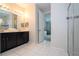 Bathroom with double vanity, shower, and access to bedroom at 9043 Sunshine Ridge Loop, Kissimmee, FL 34747