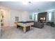 Game room with a pool table and comfortable seating area at 9043 Sunshine Ridge Loop, Kissimmee, FL 34747