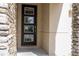 Modern front door with glass panels and stone surround at 9043 Sunshine Ridge Loop, Kissimmee, FL 34747