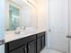 Double vanity bathroom with dark cabinets and white countertops at 9043 Sunshine Ridge Loop, Kissimmee, FL 34747