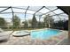 Relaxing screened pool and spa with lounge chairs at 9043 Sunshine Ridge Loop, Kissimmee, FL 34747