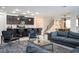 Open concept living area with kitchen and gray sectional at 9043 Sunshine Ridge Loop, Kissimmee, FL 34747