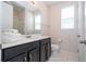 Clean bathroom with dark vanity, toilet and shower at 9043 Sunshine Ridge Loop, Kissimmee, FL 34747