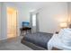 Bedroom with a queen bed, mid-century modern furniture, and ensuite bathroom at 9043 Sunshine Ridge Loop, Kissimmee, FL 34747