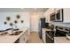 Modern kitchen with stainless steel appliances and white cabinetry at 5736 Le Marin Way, Kissimmee, FL 34758