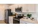 Modern kitchen with stainless steel appliances and white cabinetry at 5736 Le Marin Way, Kissimmee, FL 34758