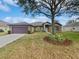 Single story house with a two-car garage and well manicured lawn at 1147 Degraw Dr, Apopka, FL 32712