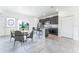 Modern kitchen with dark cabinetry, island, and dining area at 1910 Lakeview Ln, Poinciana, FL 34759