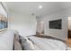 Main bedroom with a large TV and ensuite bathroom at 1910 Lakeview Ln, Poinciana, FL 34759