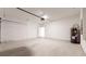 Unfinished garage with concrete floor and water heater at 1910 Lakeview Ln, Poinciana, FL 34759