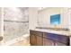 Bathroom with granite vanity, tile shower, and bathtub at 1910 Lakeview Ln, Poinciana, FL 34759