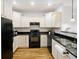 Modern kitchen with white cabinets and granite countertops at 202 E South St # 6042, Orlando, FL 32801