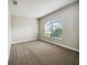 Bright bedroom with neutral carpeting and large window at 6311 Alamanda Hills Dr, Lakeland, FL 33813