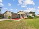 Attractive curb appeal with a red door and landscaped front yard at 6311 Alamanda Hills Dr, Lakeland, FL 33813