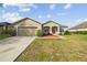 One-story home with two-car garage and red front door at 6311 Alamanda Hills Dr, Lakeland, FL 33813