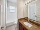 Bathroom with granite countertop and single sink vanity at 6311 Alamanda Hills Dr, Lakeland, FL 33813