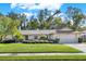 House exterior showcasing a well-maintained lawn and landscaping at 734 Riverbend Blvd, Longwood, FL 32779